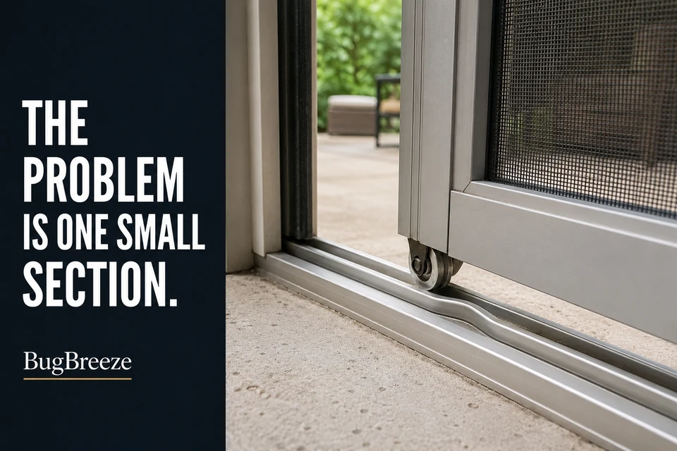 Sliding screen-door roller approaching a small bent section of aluminum track.